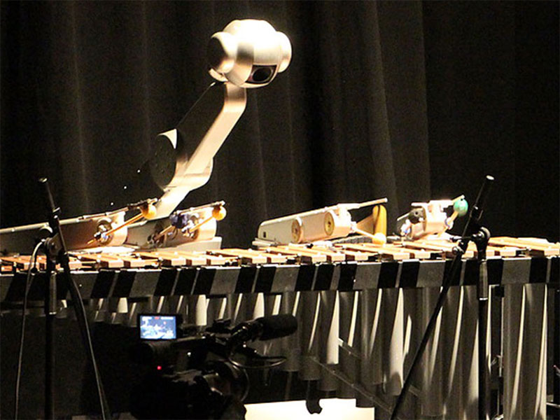 Shimon the robotic, improvising, and singing robot plays music with graduate students.